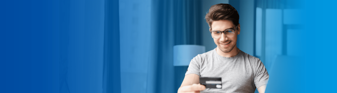 Young man looking at a debit card