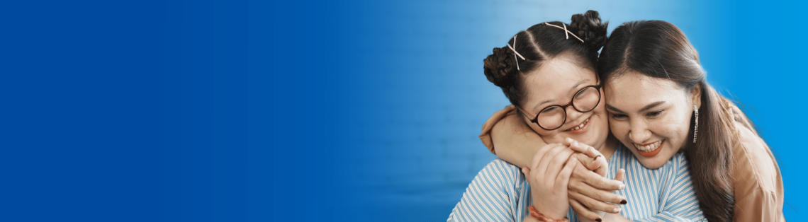 Woman hugging girl with Down syndrome