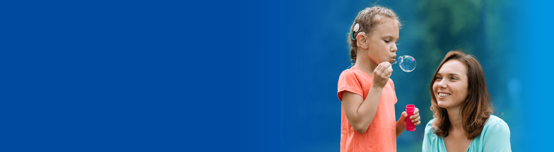 Young girl blowing bubbles